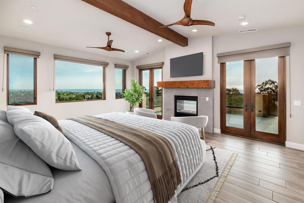 6768 Strawberry Place Carlsbad, CA 92011 - Photo 26 of 53 a spacious bedroom with a large bed and a fireplace