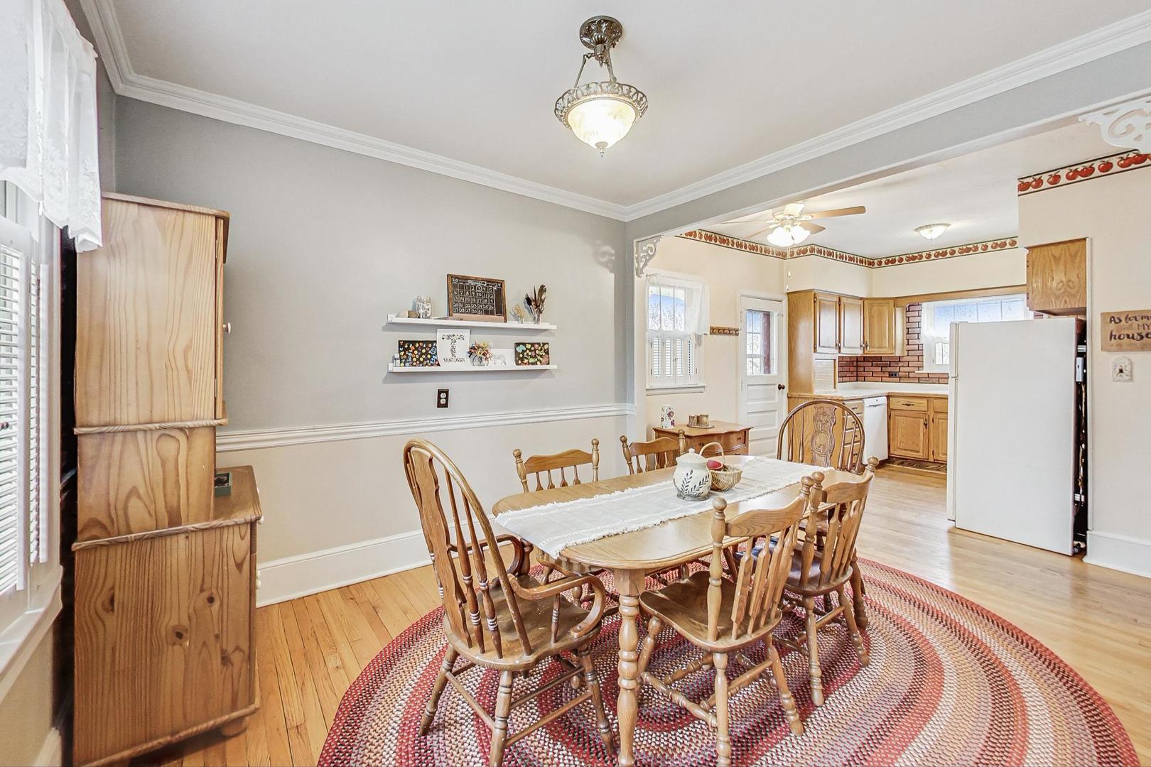 26W136 Jewell Road Wheaton, IL 60187 - Photo 11 of 35 a view of a dining room with furniture and a refrigerator