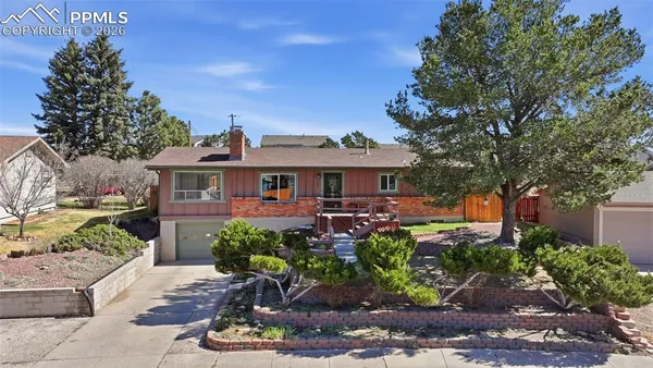 a front view of a house with a yard garage and outdoor seating