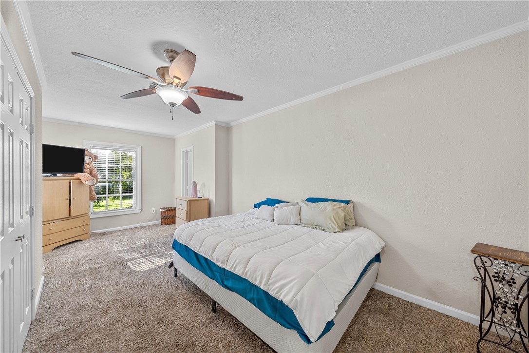 3600 Sanger Avenue Waco, TX 76710 - Photo 10 of 24 a bedroom with a bed window and a flat screen tv