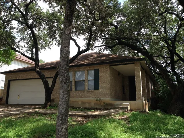 a view of a house with a large tree