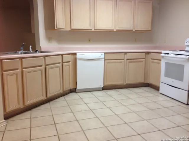 a kitchen with white cabinets