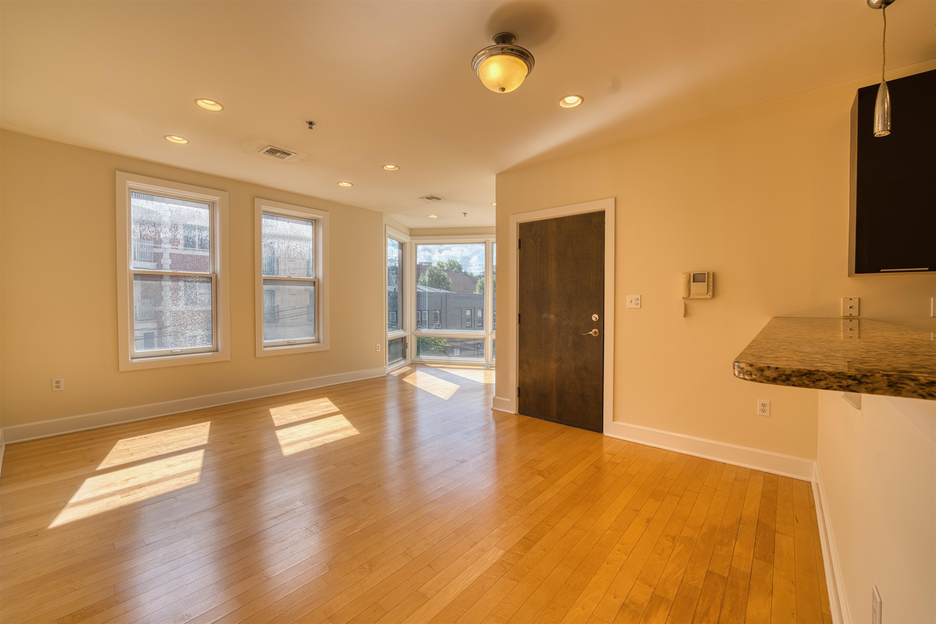 108 Jackson Street, Unit 3A Hoboken, NJ 07030 - Photo 15 of 30 a view of an empty room with wooden floor and a window