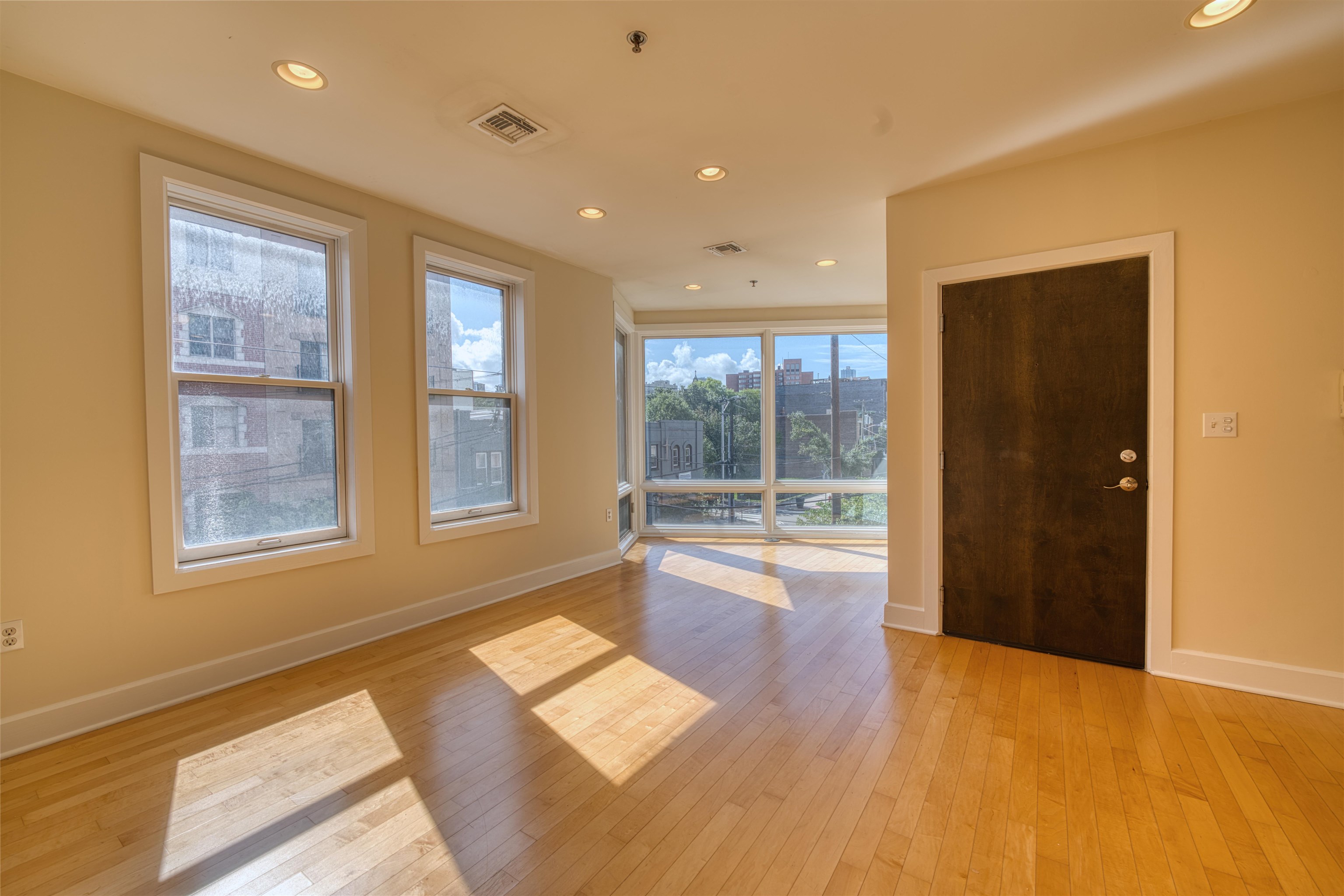 108 Jackson Street, Unit 3A Hoboken, NJ 07030 - Photo 23 of 30 a view of an empty room with a window and wooden floor