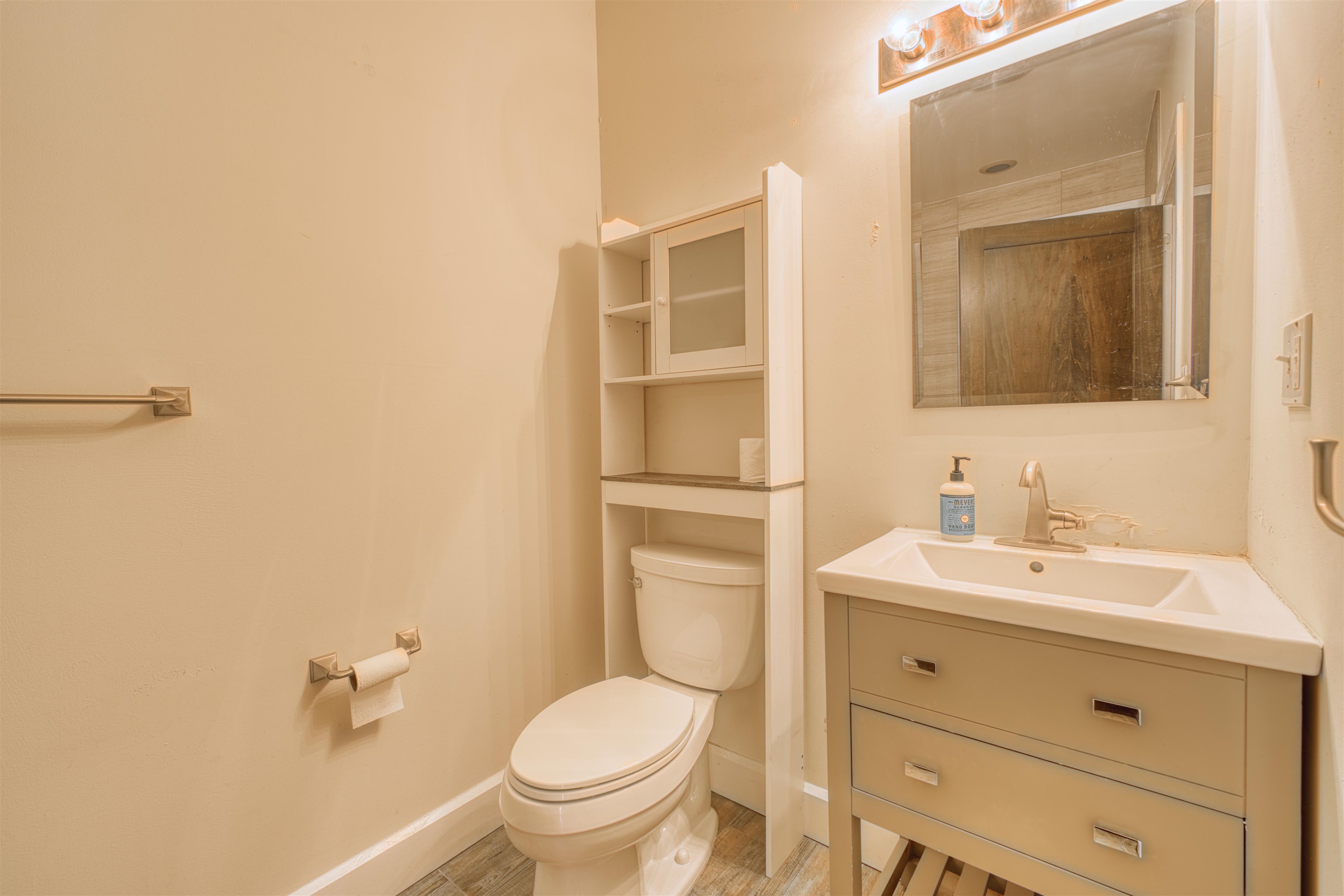 108 Jackson Street, Unit 3A Hoboken, NJ 07030 - Photo 24 of 30 a bathroom with a toilet a sink a mirror and vanity