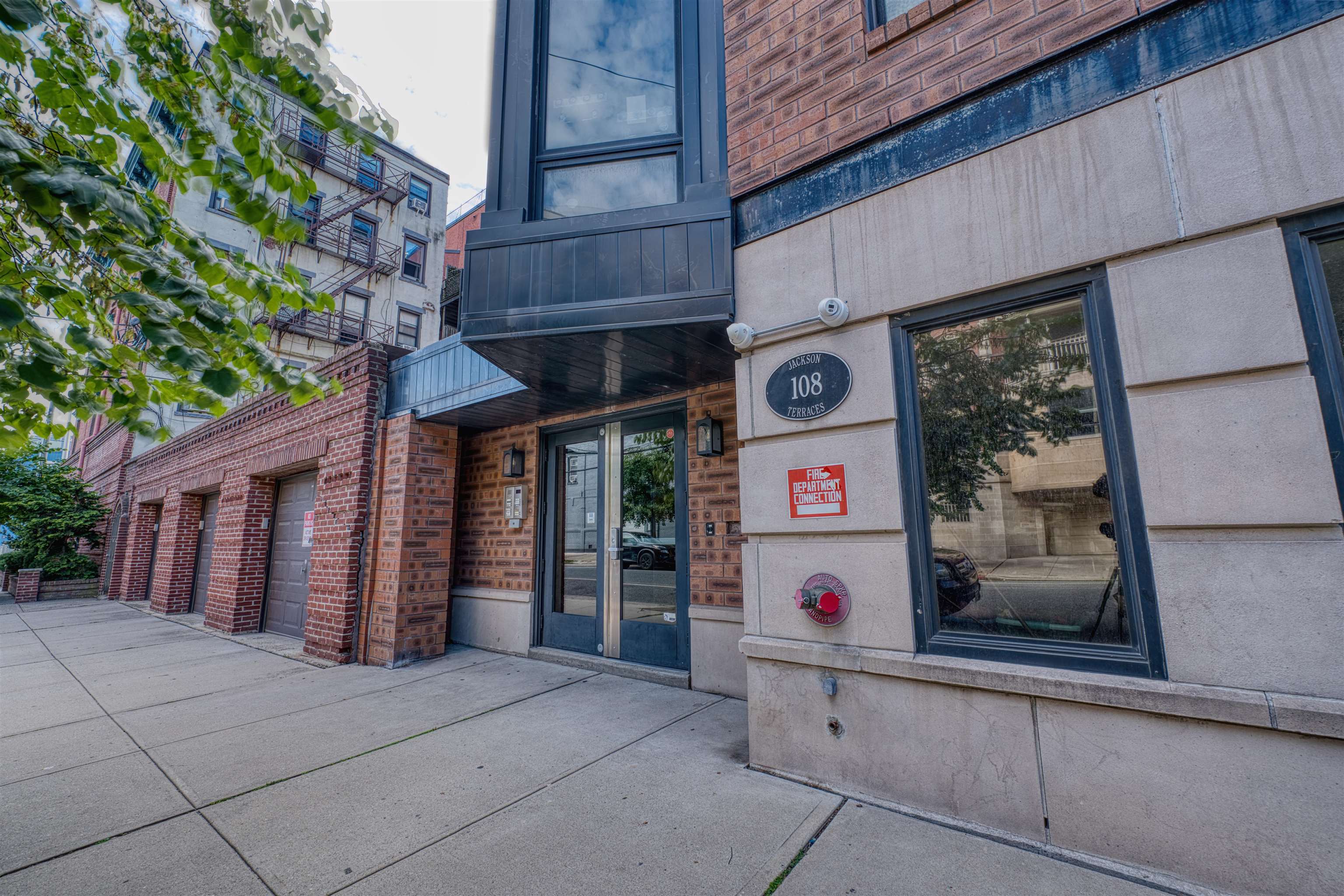 108 Jackson Street, Unit 3A Hoboken, NJ 07030 - Photo 29 of 30 a front view of a building with traffic signal lights