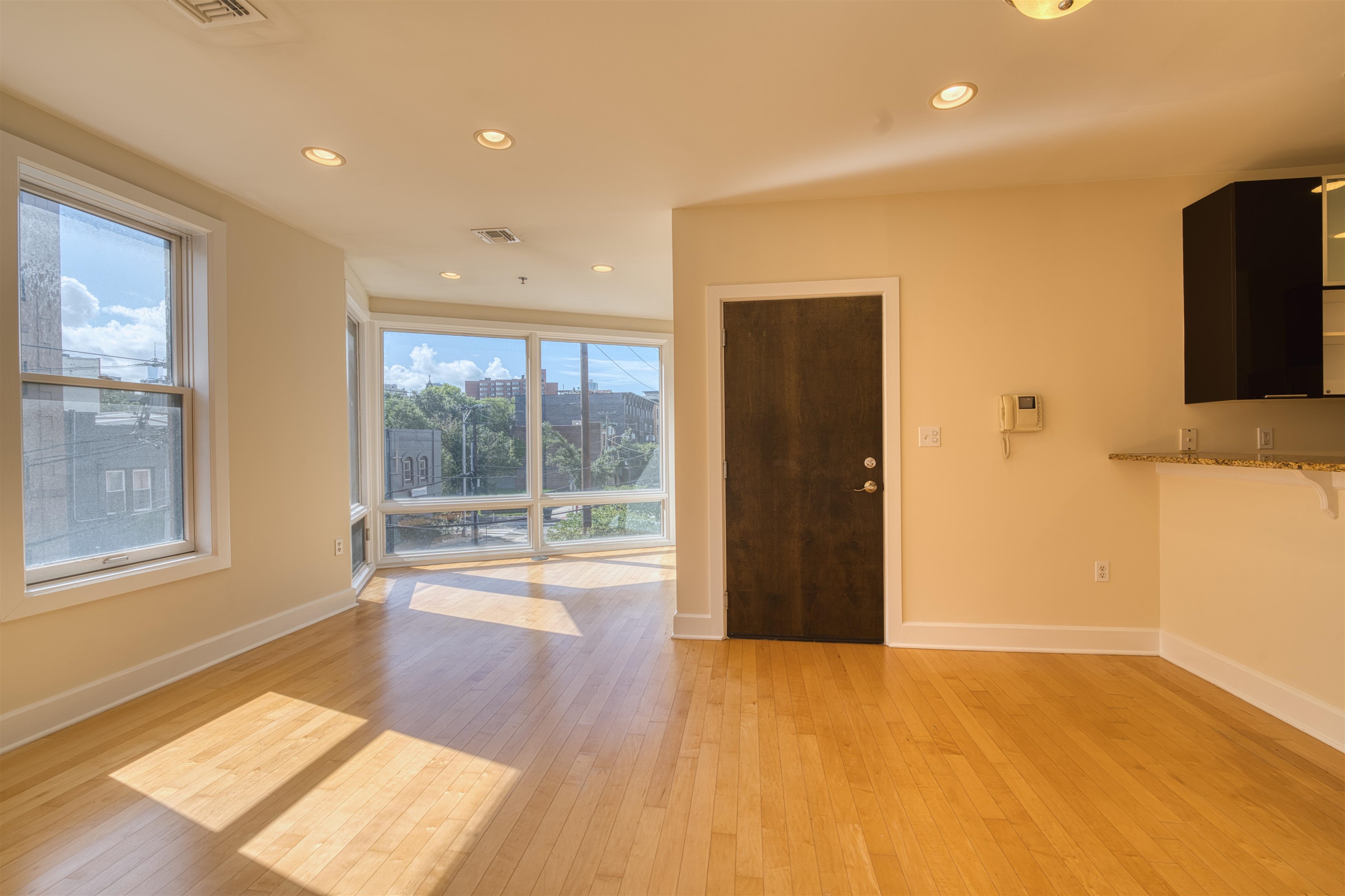 108 Jackson Street, Unit 3A Hoboken, NJ 07030 - Photo 3 of 30 a view of an empty room with a window and wooden floor