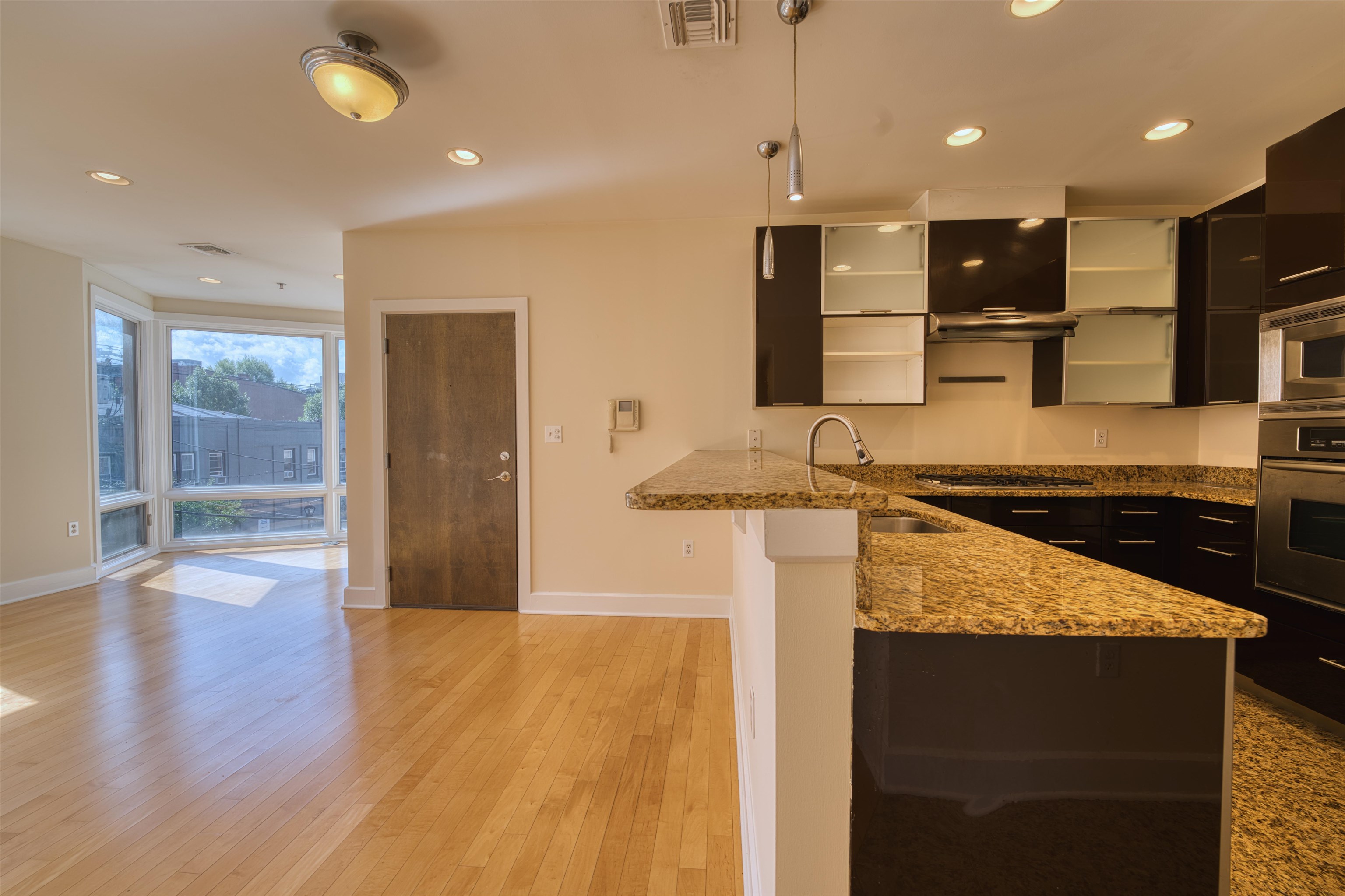 108 Jackson Street, Unit 3A Hoboken, NJ 07030 - Photo 4 of 30 a kitchen with stainless steel appliances granite countertop a sink a stove and a wooden floors