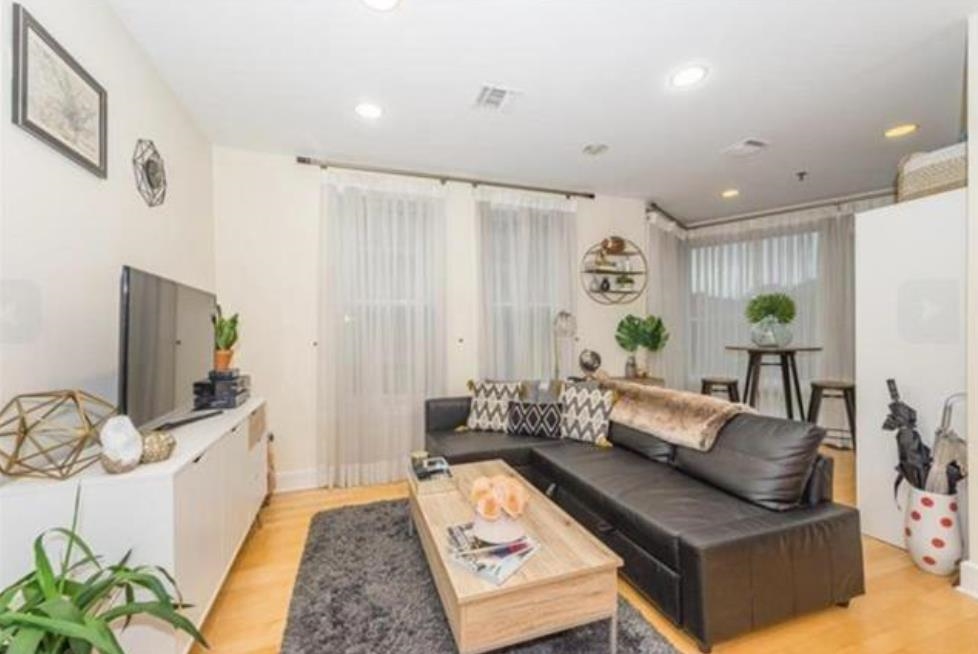 108 Jackson Street, Unit 3A Hoboken, NJ 07030 - Photo 9 of 30 a living room with furniture and a flat screen tv
