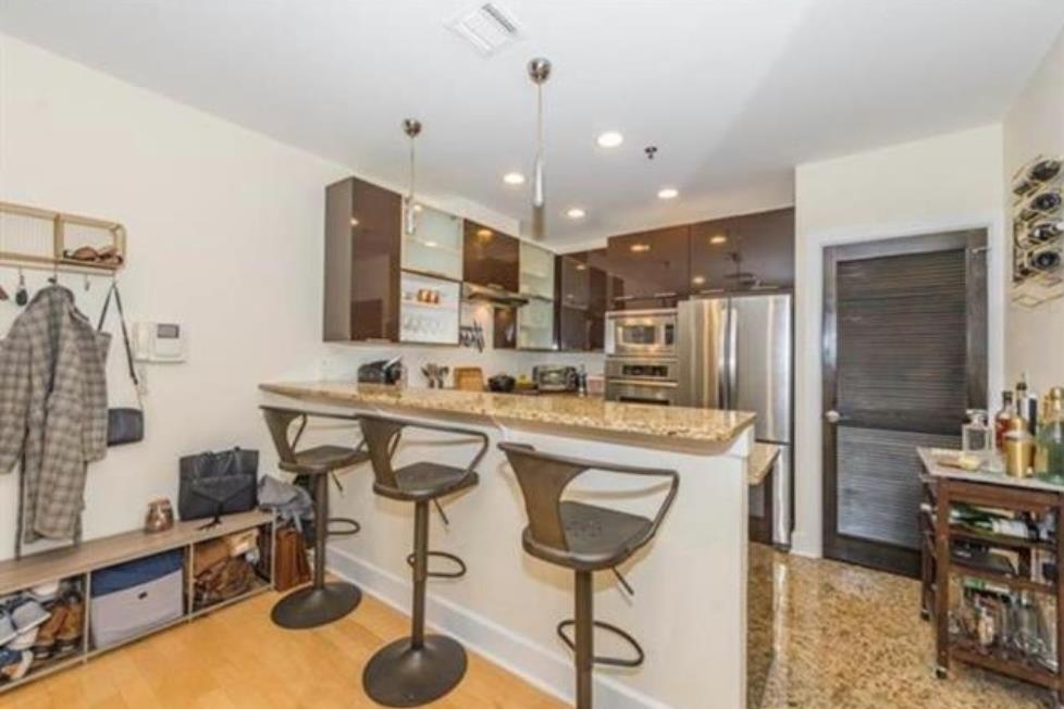 108 Jackson Street, Unit 3A Hoboken, NJ 07030 - Photo 10 of 30 a kitchen with stainless steel appliances granite countertop a sink a stove and a refrigerator