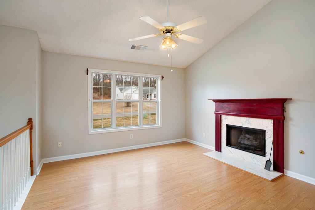 8440 River Bluff Place Ball Ground, GA 30107 - Photo 11 of 73 a view of an empty room with window and fire place