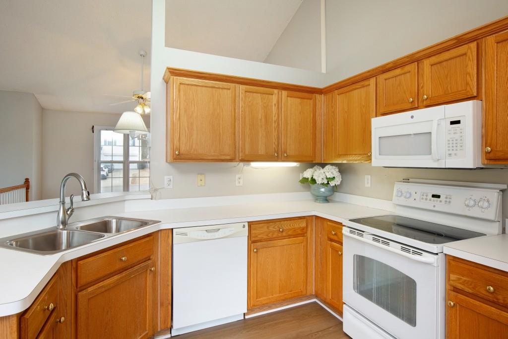 8440 River Bluff Place Ball Ground, GA 30107 - Photo 28 of 73 a kitchen with stainless steel appliances granite countertop a sink a stove and cabinets