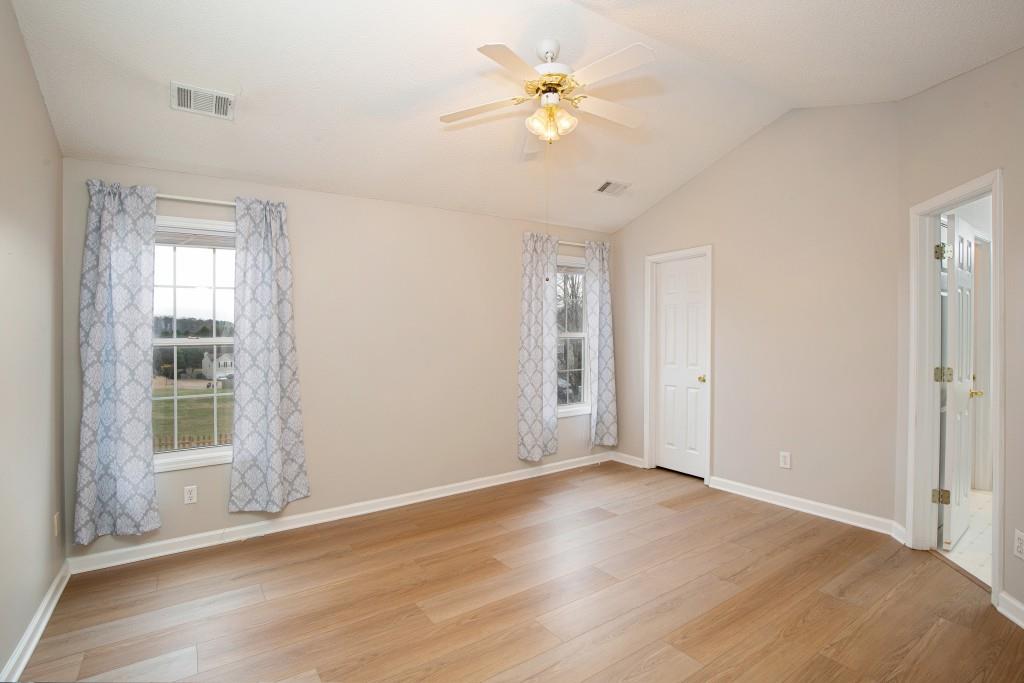 8440 River Bluff Place Ball Ground, GA 30107 - Photo 33 of 73 wooden floor in an empty room with a window