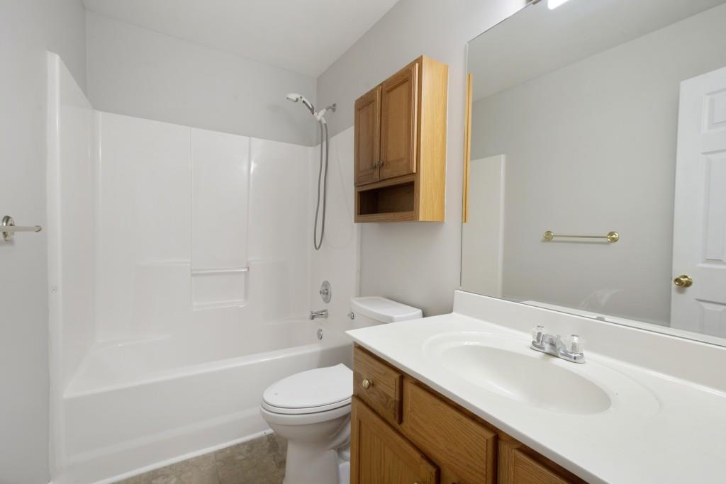 8440 River Bluff Place Ball Ground, GA 30107 - Photo 41 of 73 a bathroom with a sink a toilet and a bathtub