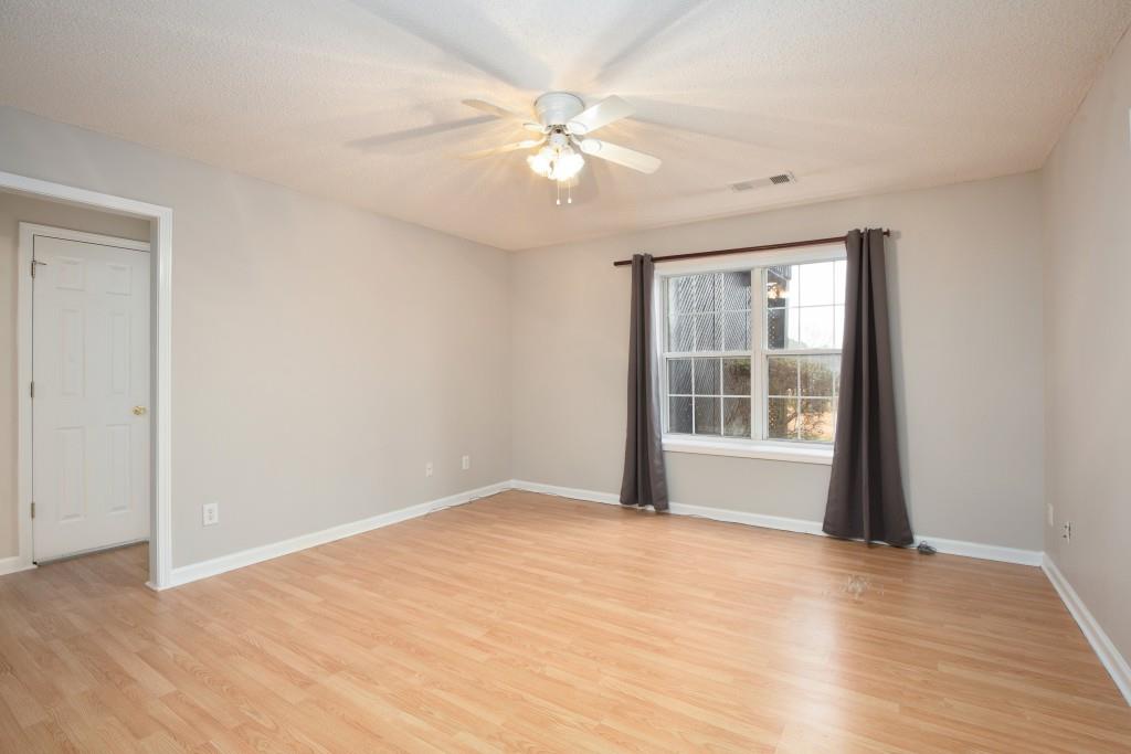 8440 River Bluff Place Ball Ground, GA 30107 - Photo 42 of 73 a view of an empty room with wooden floor and a window