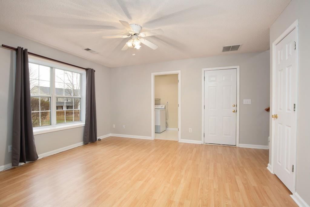 8440 River Bluff Place Ball Ground, GA 30107 - Photo 44 of 73 a view of an empty room with a window and wooden floor