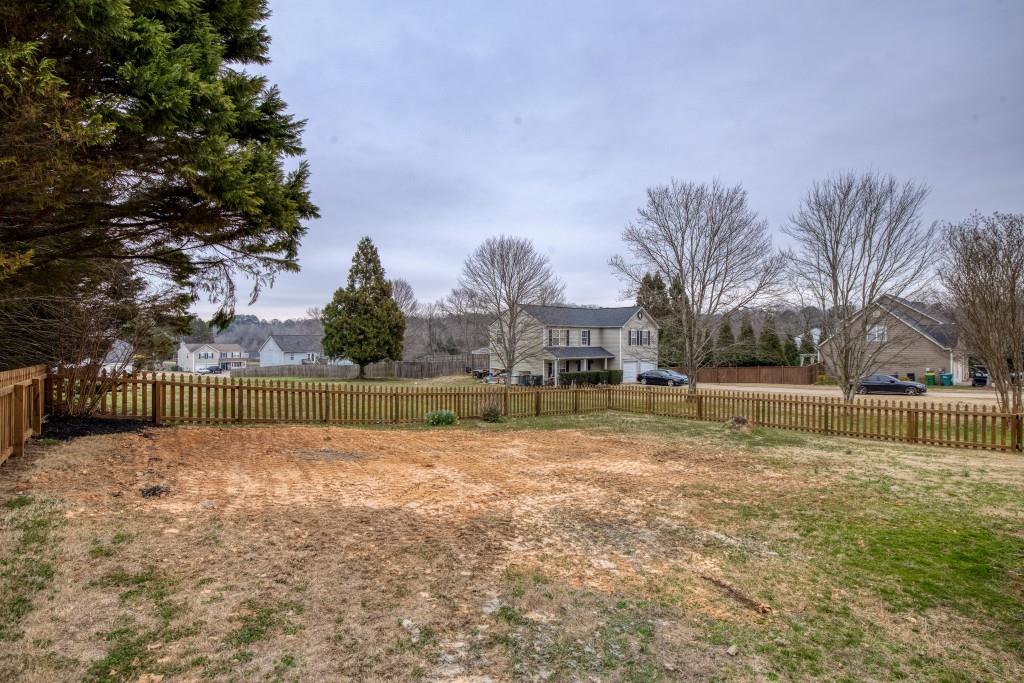 8440 River Bluff Place Ball Ground, GA 30107 - Photo 53 of 73 a view of swimming pool with a yard and a fountain