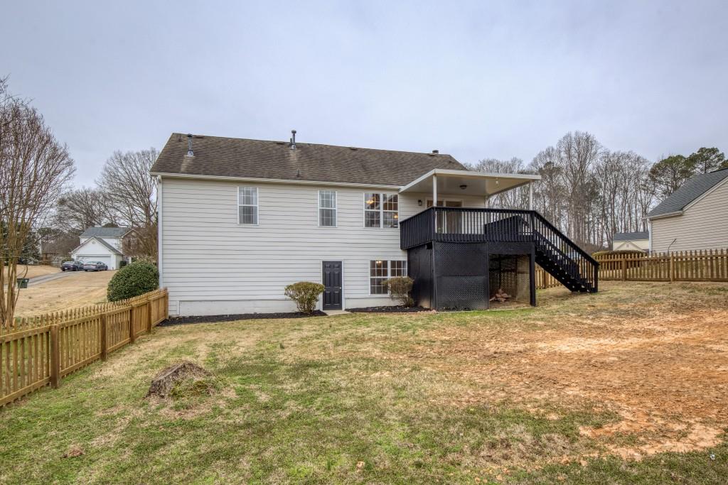8440 River Bluff Place Ball Ground, GA 30107 - Photo 56 of 73 a view of a house with a yard