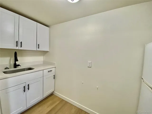 a white refrigerator freezer and a stove sitting inside of a kitchen