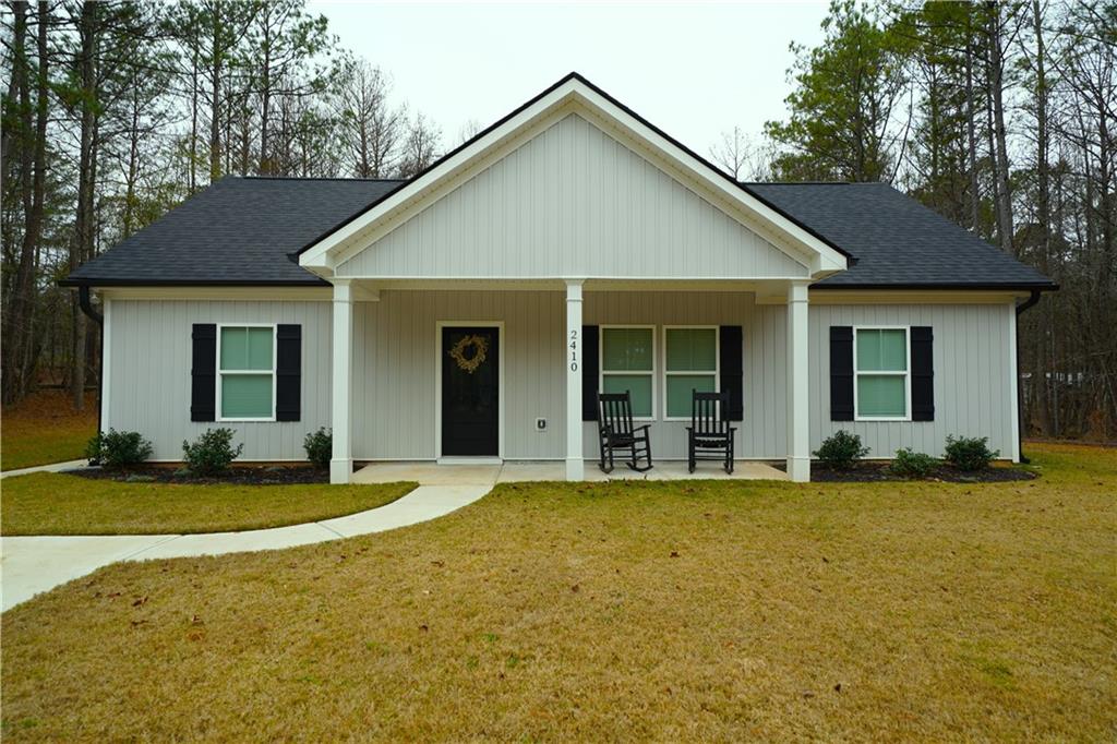 a view of a house with backyard sitting area and garden