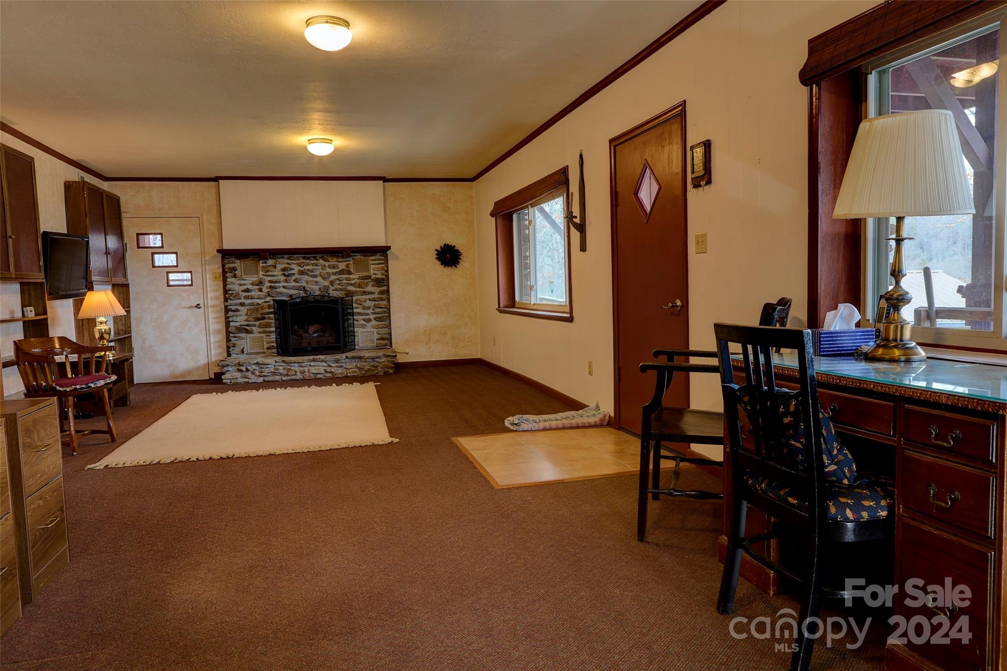 344 Pine Ridge Trail Almond, NC 28702 - Photo 15 of 34 a living room with furniture a fireplace and a dining table with wooden floor