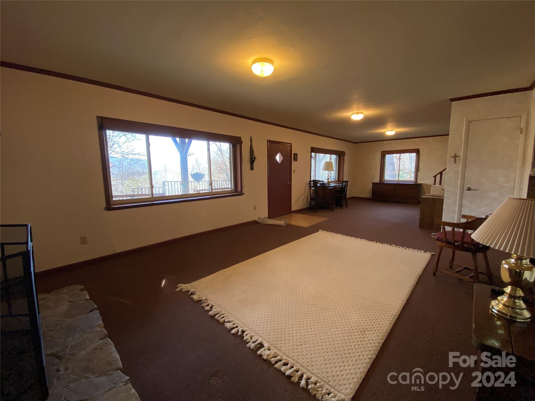 344 Pine Ridge Trail Almond, NC 28702 - Photo 17 of 34 a big room with wooden floor and windows