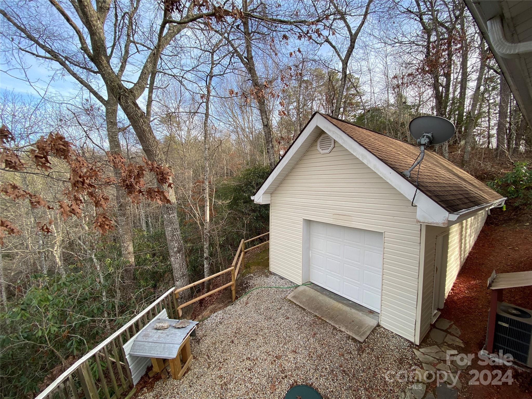 344 Pine Ridge Trail Almond, NC 28702 - Photo 32 of 34 a view of a small house with a large window and wooden fence