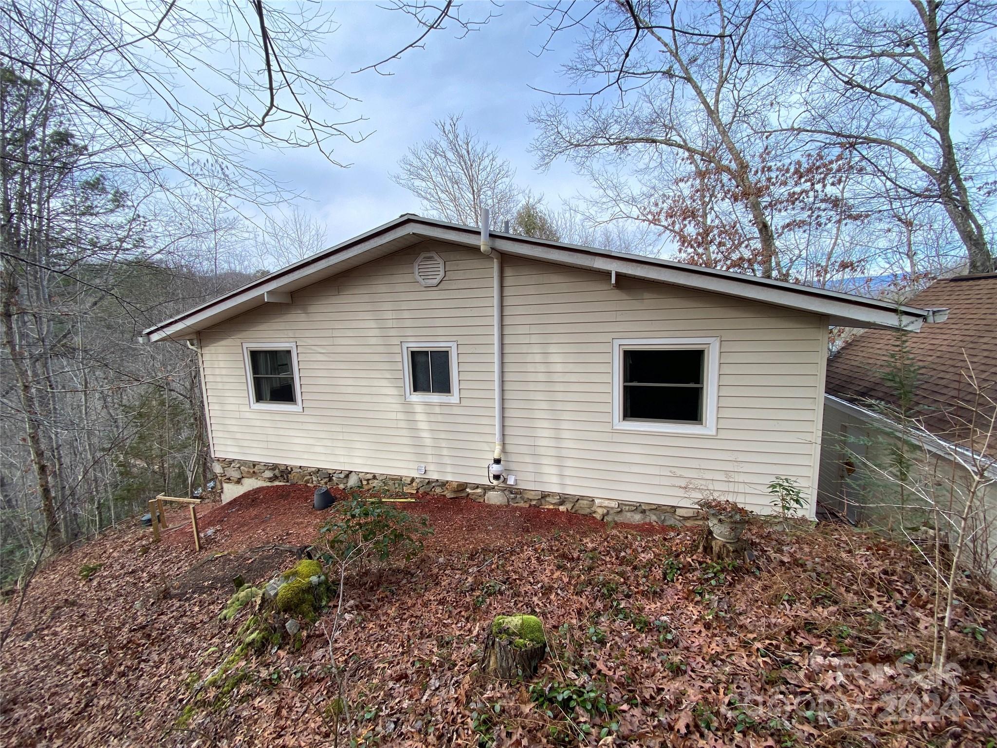 344 Pine Ridge Trail Almond, NC 28702 - Photo 33 of 34 a backyard of a house with large trees and wooden fence