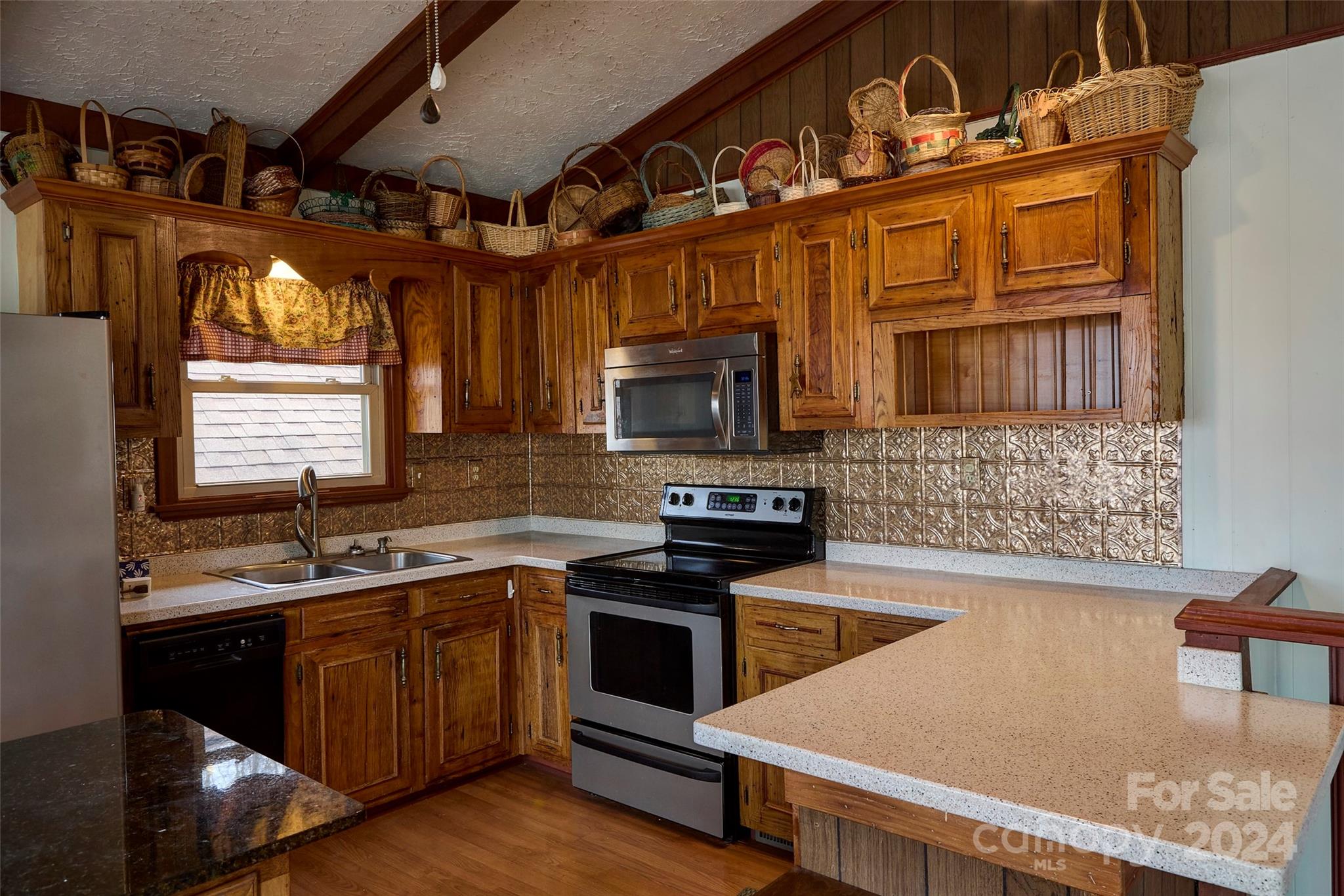 344 Pine Ridge Trail Almond, NC 28702 - Photo 5 of 34 a kitchen with stainless steel appliances granite countertop a stove a sink and a microwave