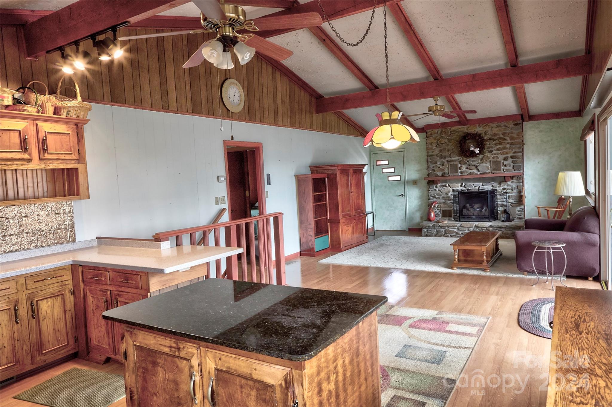 344 Pine Ridge Trail Almond, NC 28702 - Photo 6 of 34 a kitchen with stainless steel appliances granite countertop a sink a counter space and a chandelier