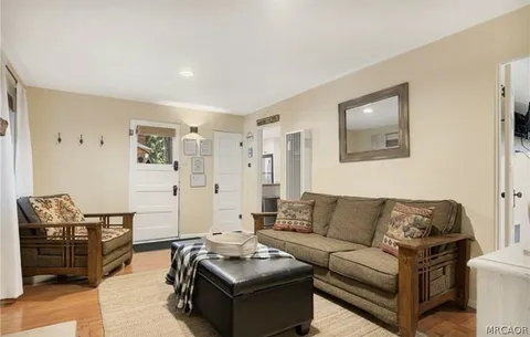 a living room with furniture a couch and a stove top oven