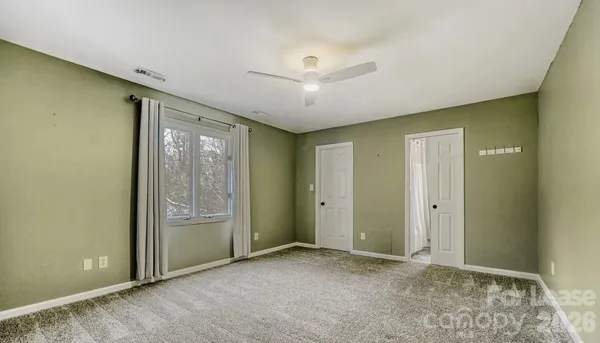 an empty room with windows and closet