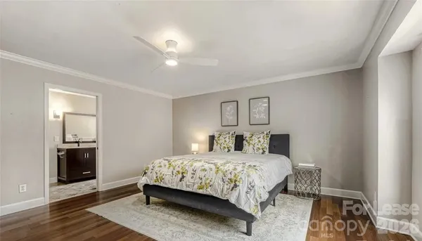 a bedroom with a bed and a view of kitchen