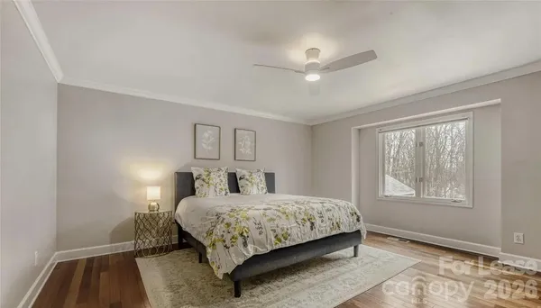 a bedroom with a bed lamp and window