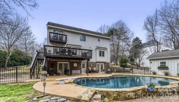 a view of a house with swimming pool and sitting area