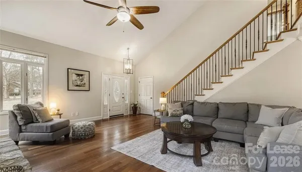 a living room with furniture and a wooden floor