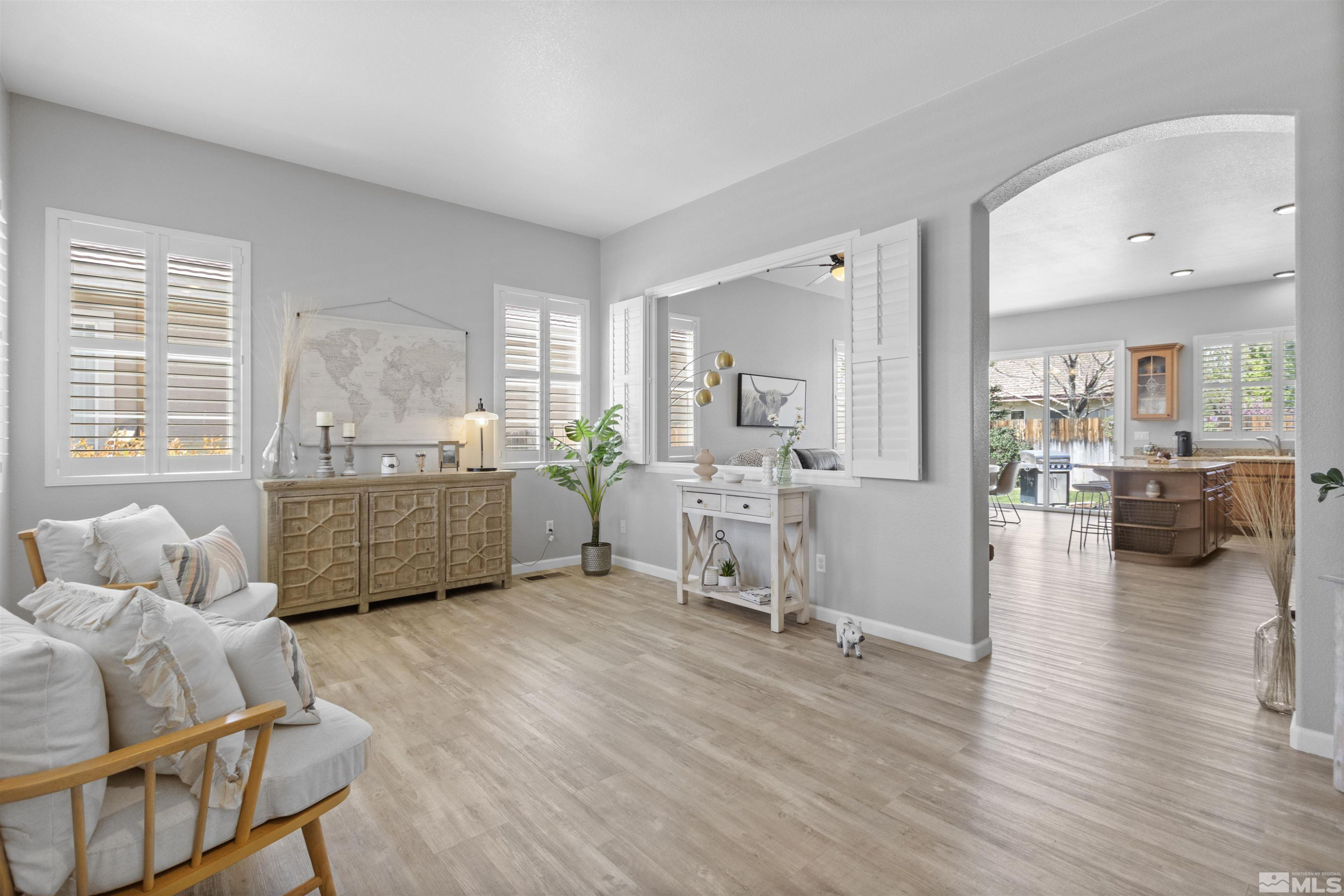 1685 Legacy Village Road Reno, NV 89521 - Photo 3 of 27 a living room with furniture and a wooden floor