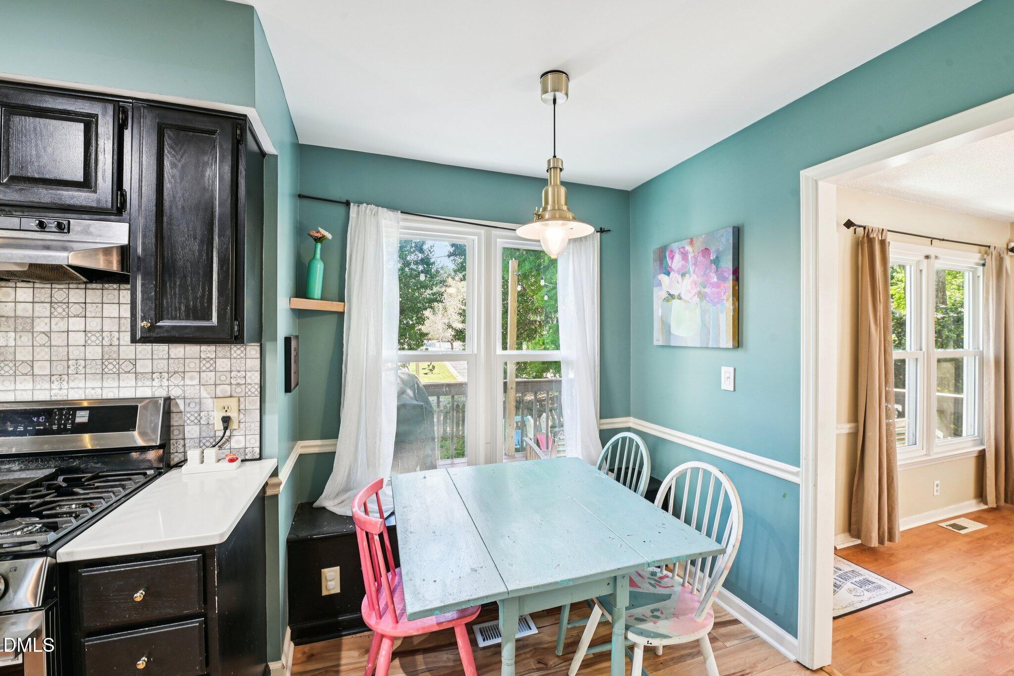 4508 Emmit Drive Raleigh, NC 27604 - Photo 11 of 42 a view of a dining room with furniture window and wooden floor