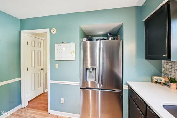 a kitchen with stainless steel appliances granite countertop a refrigerator and a sink