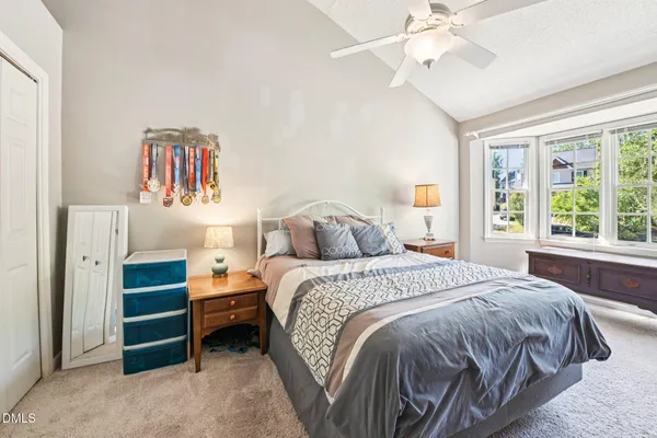 a bedroom with a bed and a window
