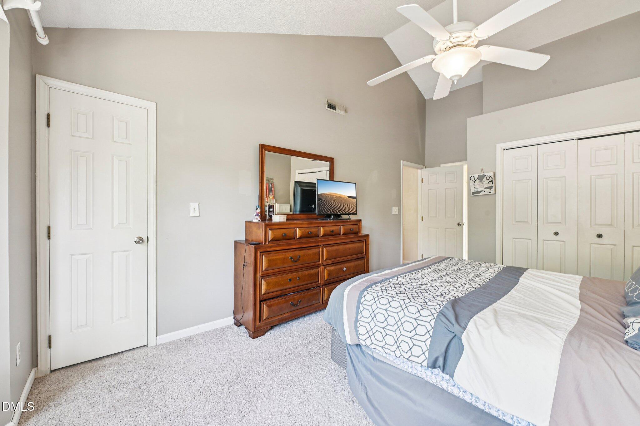 4508 Emmit Drive Raleigh, NC 27604 - Photo 19 of 42 a bedroom with a bed and a chandelier