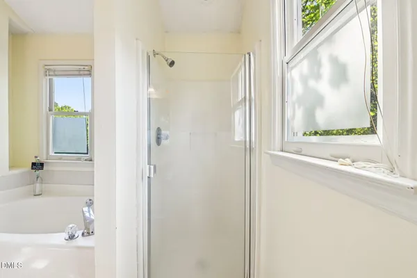 a bathroom with a bathtub and a shower