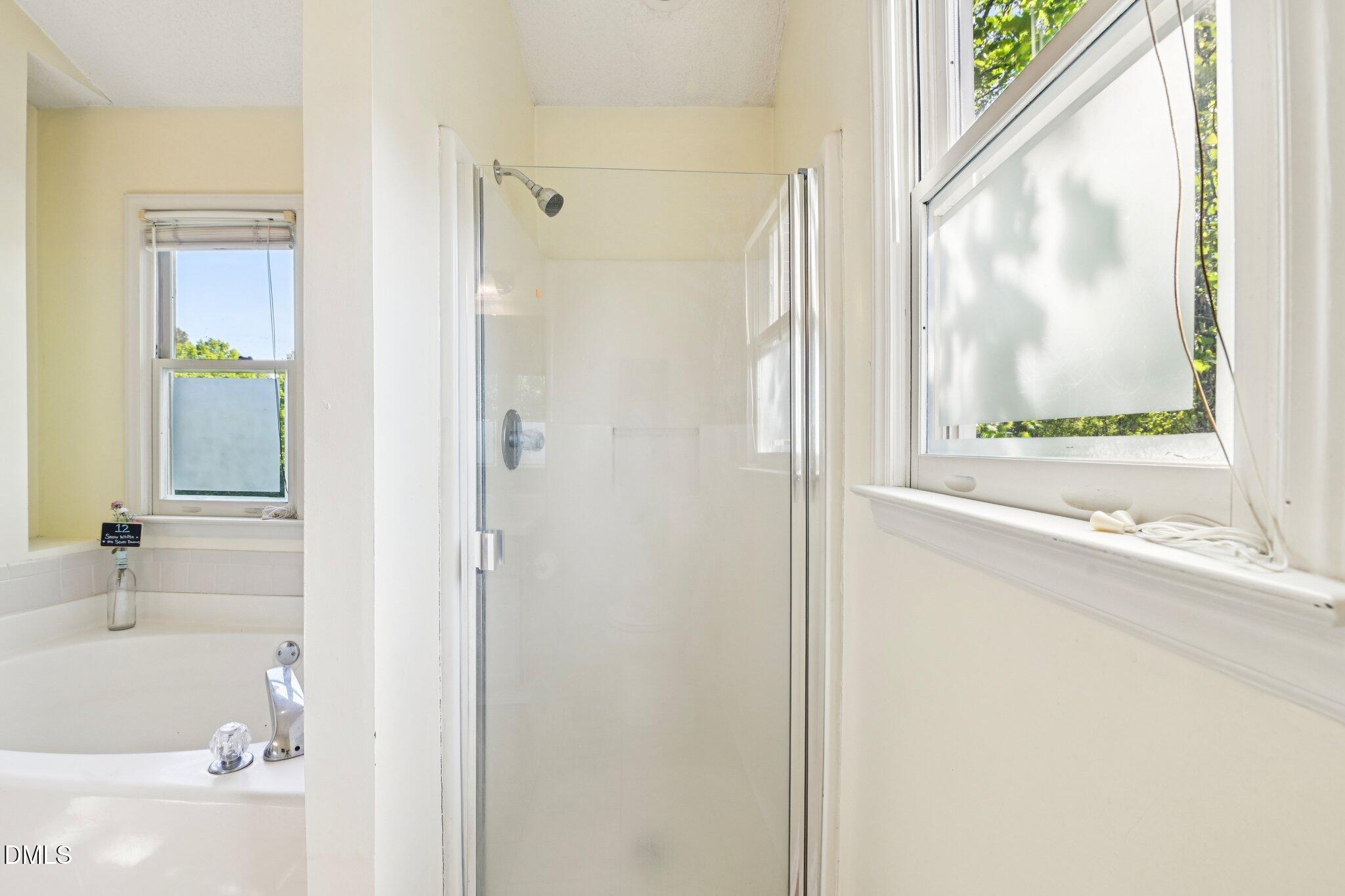 4508 Emmit Drive Raleigh, NC 27604 - Photo 21 of 42 a bathroom with a bathtub and a shower