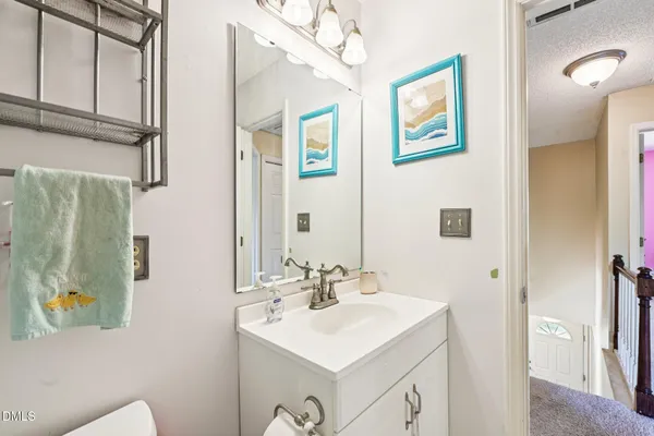 a bathroom with a sink mirror and vanity