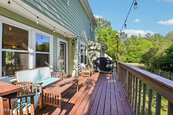a view of balcony with wooden floor and outdoor seating
