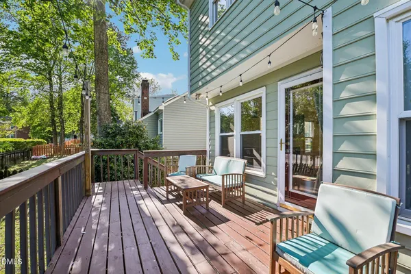 a view of balcony with wooden floor and outdoor seating