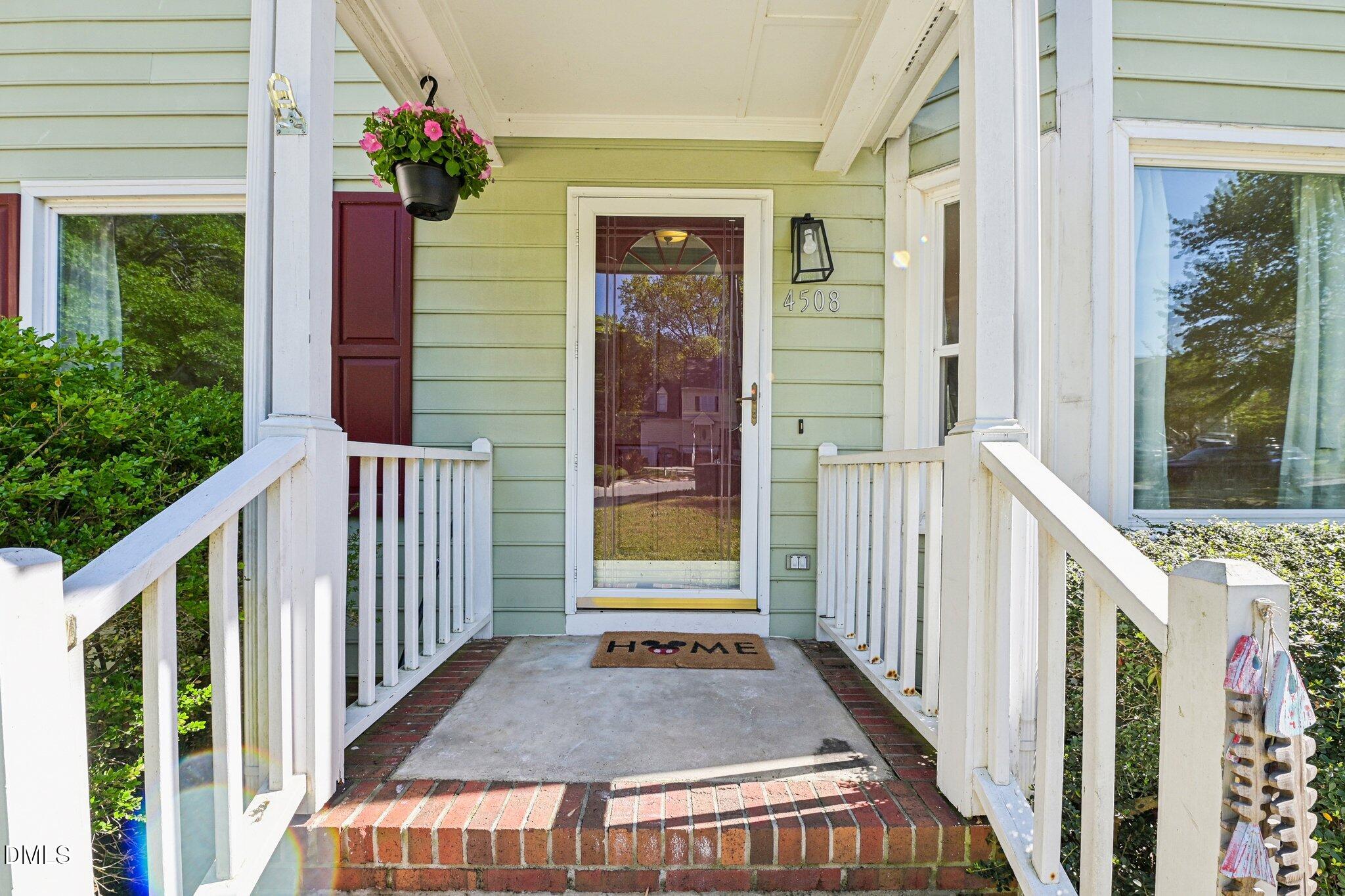 4508 Emmit Drive Raleigh, NC 27604 - Photo 4 of 42 a view of a porch with wooden floor and front door