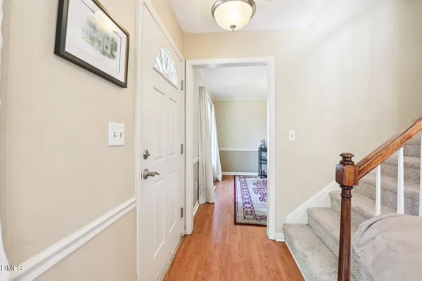 a view of a hallway with wooden floor and staircase