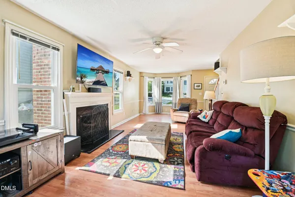 a living room with furniture fireplace and flat screen tv
