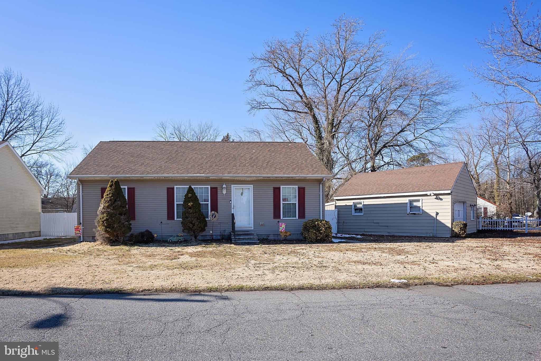 1303 Colonial Avenue Cambridge, MD 21613 - Photo 1 of 12 a front view of a house with a yard